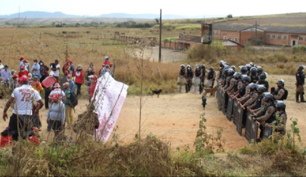 a group of people in helmets and helmets are gathered around a large banner